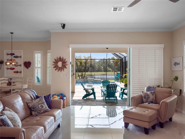 living room featuring ornamental molding, a healthy amount of sunlight, and light tile patterned flooring