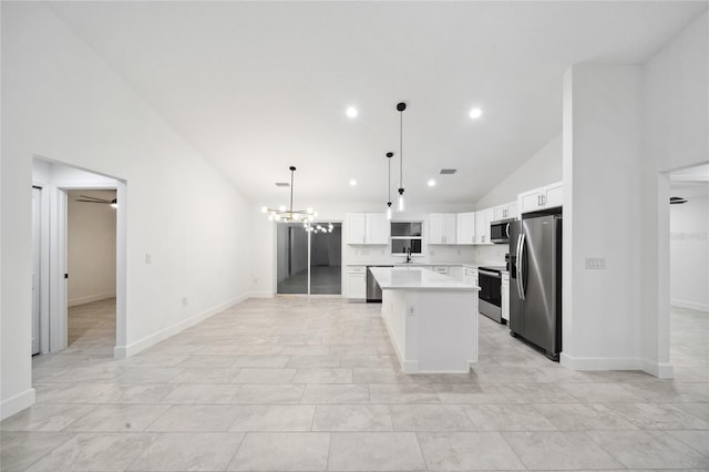 kitchen featuring a notable chandelier, a center island, hanging light fixtures, appliances with stainless steel finishes, and white cabinets