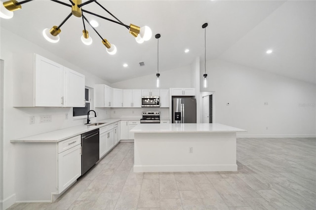 kitchen featuring a center island, sink, white cabinetry, hanging light fixtures, and appliances with stainless steel finishes