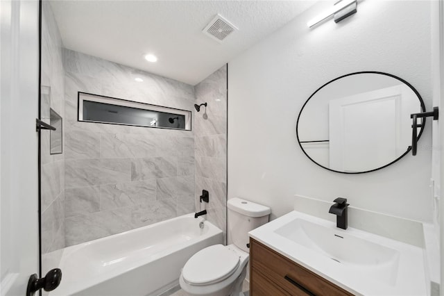 full bathroom with toilet, vanity, and tiled shower / bath