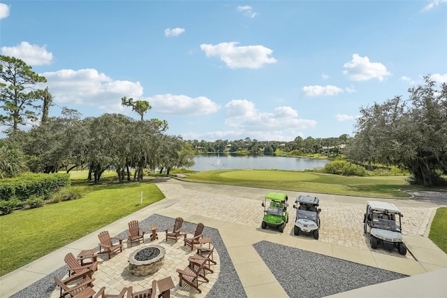 surrounding community featuring a patio, a water view, a lawn, and an outdoor fire pit