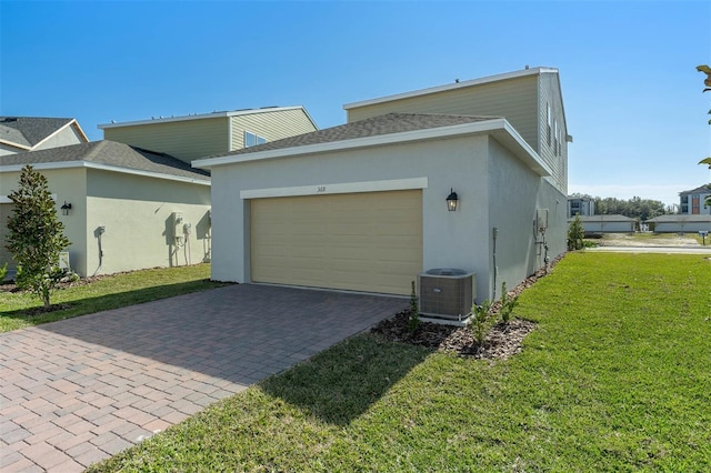 view of home's exterior featuring cooling unit, a yard, and a garage