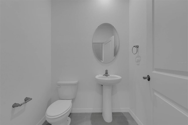 bathroom featuring tile patterned floors and toilet