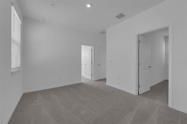 empty room featuring light colored carpet