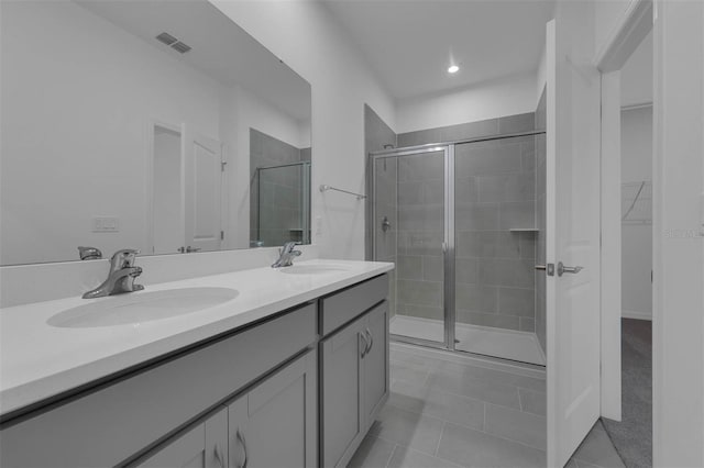 bathroom featuring vanity, tile patterned floors, and a shower with shower door