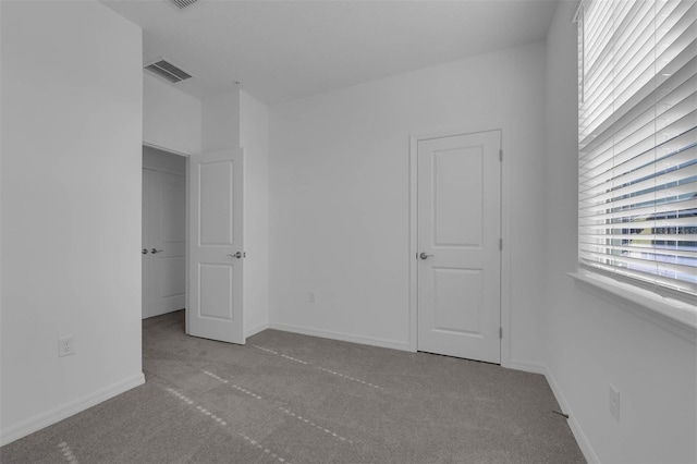 unfurnished bedroom with light colored carpet