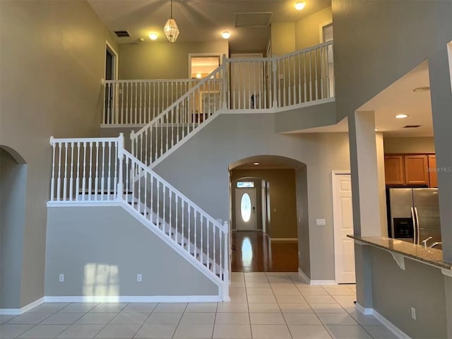 tiled foyer entrance featuring a high ceiling