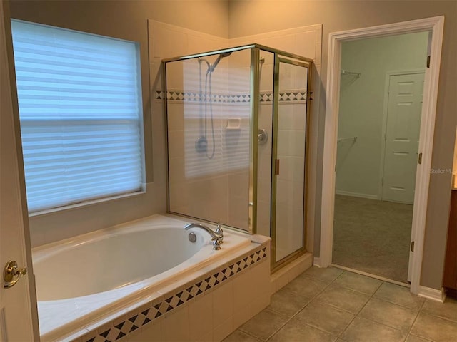 bathroom featuring tile patterned flooring and plus walk in shower