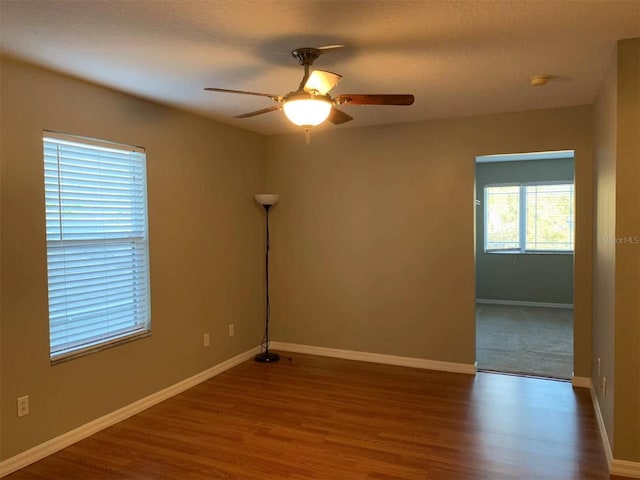 spare room featuring ceiling fan and dark hardwood / wood-style flooring