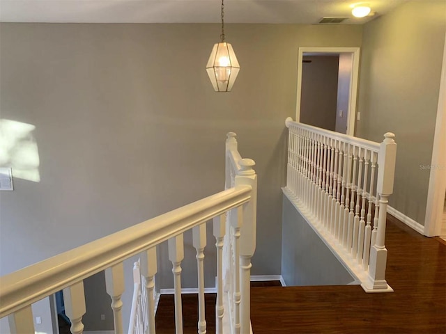 stairs featuring hardwood / wood-style floors