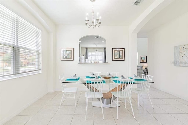 dining space with a notable chandelier, light tile patterned floors, and plenty of natural light