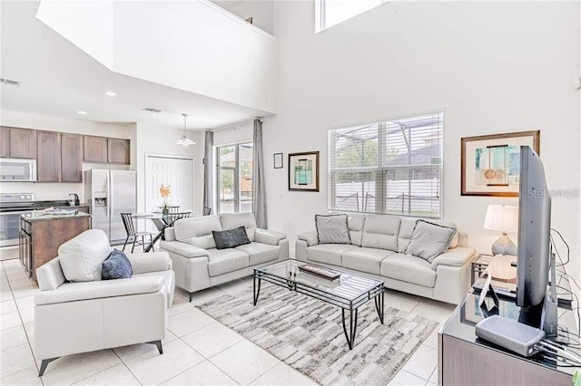 tiled living room with a high ceiling