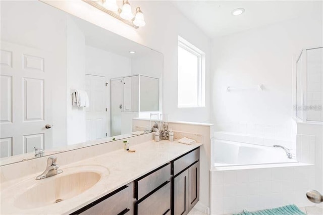 bathroom featuring separate shower and tub and vanity