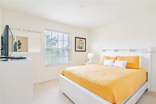 bedroom featuring light colored carpet