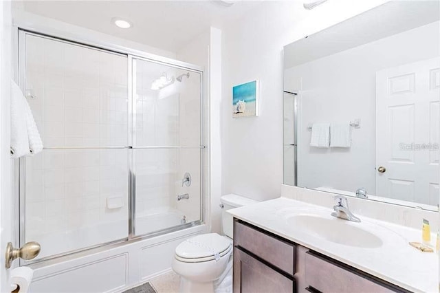 full bathroom with toilet, vanity, and combined bath / shower with glass door