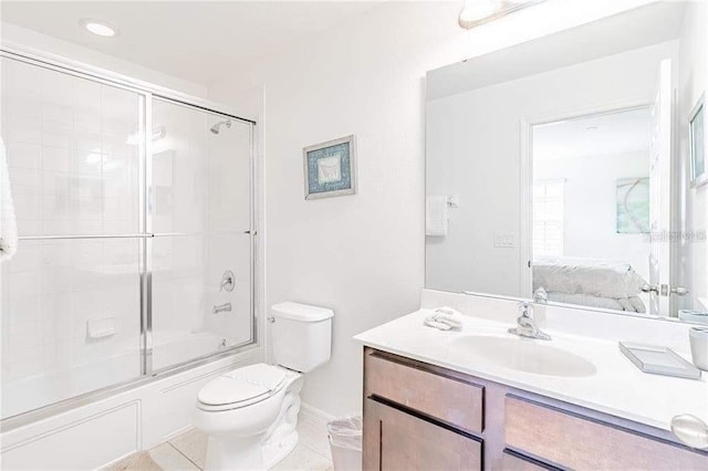 full bathroom featuring toilet, tile patterned flooring, combined bath / shower with glass door, and vanity