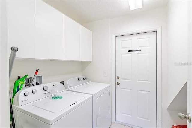 washroom with independent washer and dryer and cabinets