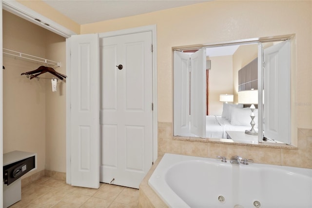 bathroom featuring tile patterned flooring and tiled tub