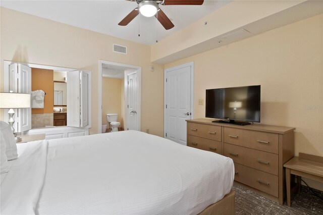 bedroom featuring ensuite bath and ceiling fan