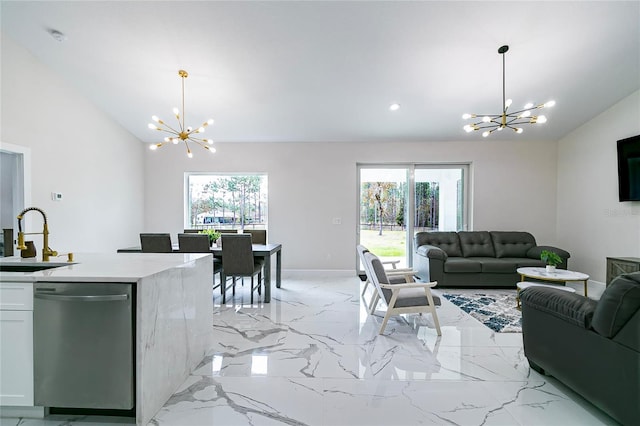 living room with lofted ceiling, a notable chandelier, and sink