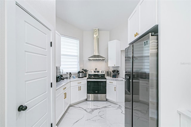 kitchen with appliances with stainless steel finishes, tasteful backsplash, wall chimney range hood, white cabinets, and light stone counters