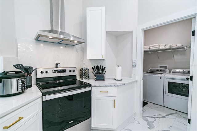 kitchen featuring stainless steel range with electric stovetop, white cabinetry, washing machine and clothes dryer, backsplash, and wall chimney exhaust hood