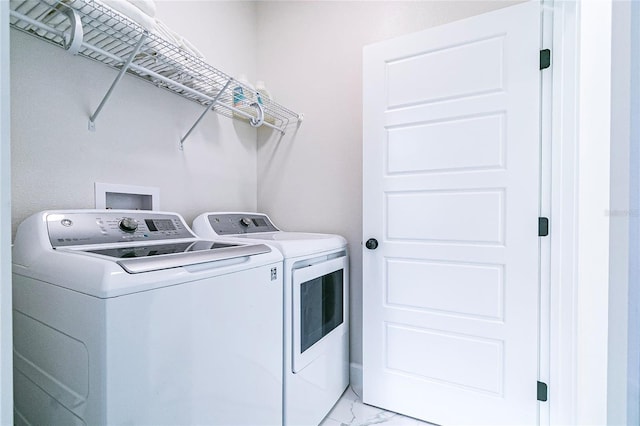 clothes washing area featuring washer and clothes dryer