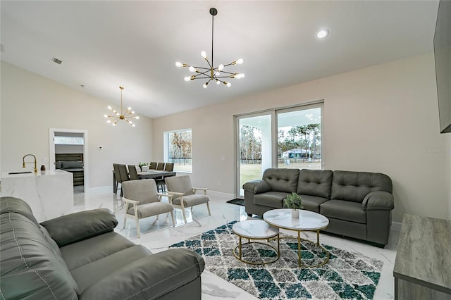 living room with vaulted ceiling, a chandelier, and sink