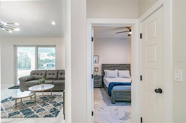 bedroom with ceiling fan with notable chandelier