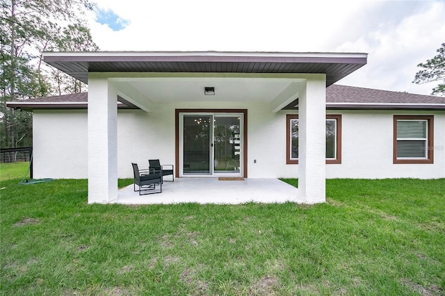 rear view of property featuring a patio area and a yard