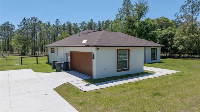 view of home's exterior featuring a garage, a lawn, and central AC