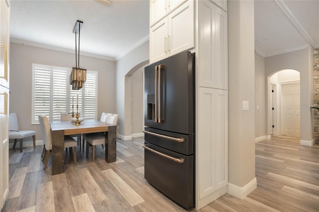 kitchen with decorative light fixtures, crown molding, white cabinetry, and high end fridge