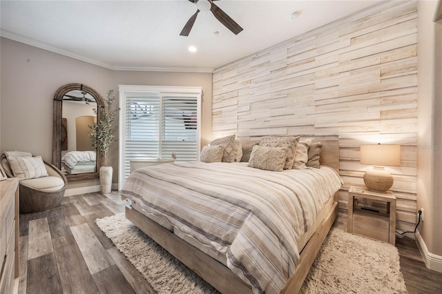 bedroom with ceiling fan, dark wood-type flooring, and ornamental molding