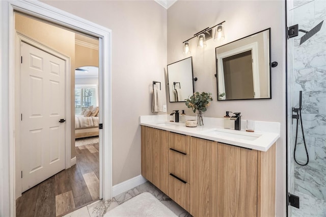 bathroom featuring a shower with shower door, hardwood / wood-style flooring, vanity, and crown molding