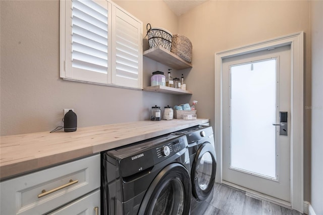 laundry area with washer and dryer and hardwood / wood-style flooring