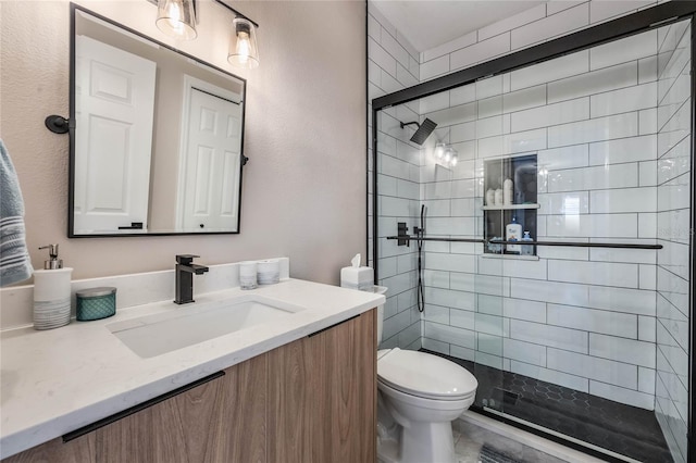 bathroom featuring an enclosed shower, vanity, and toilet