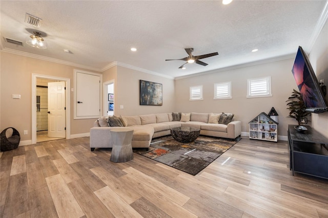 living room featuring a textured ceiling, ceiling fan, crown molding, and light hardwood / wood-style floors