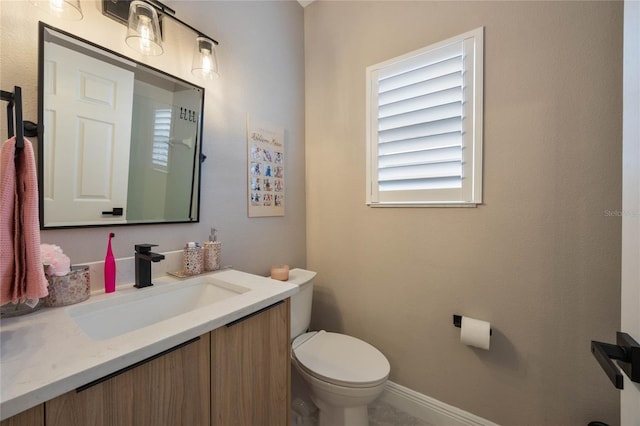 bathroom with toilet and vanity