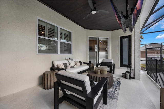 view of patio featuring a lanai, an outdoor living space, and ceiling fan