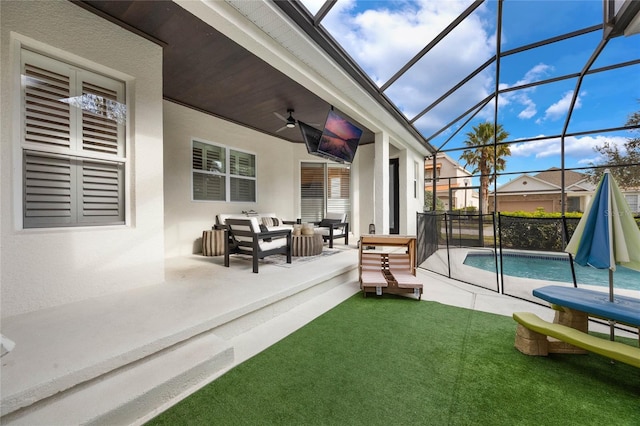 sunroom with ceiling fan and a swimming pool