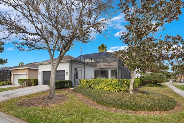 view of front facade with a garage, a lanai, and a front lawn