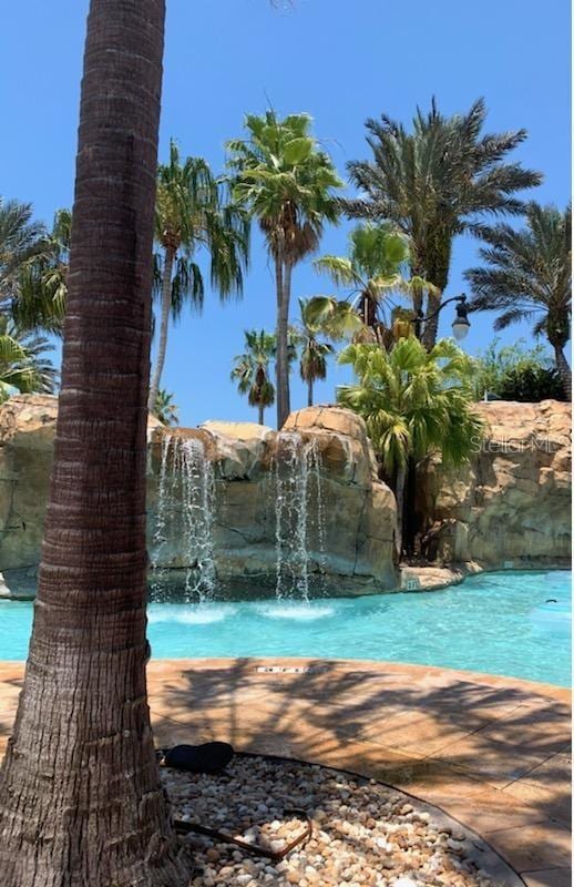 view of pool with pool water feature