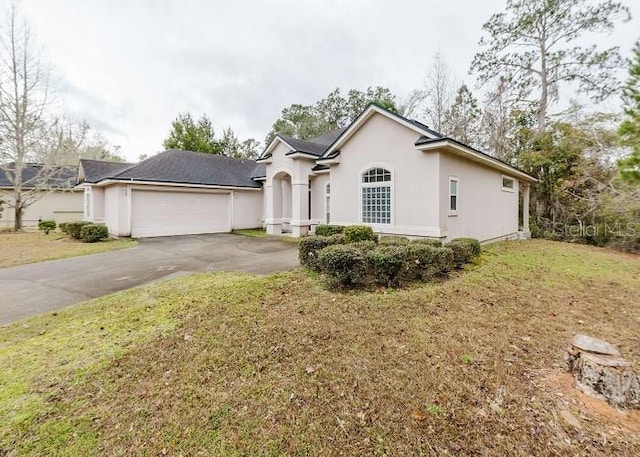 ranch-style house featuring a front lawn and a garage