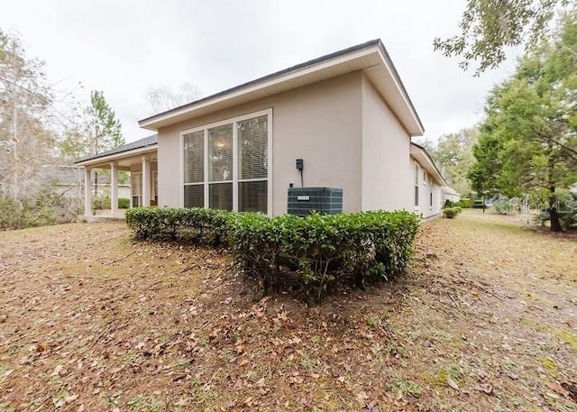 view of side of home featuring central AC