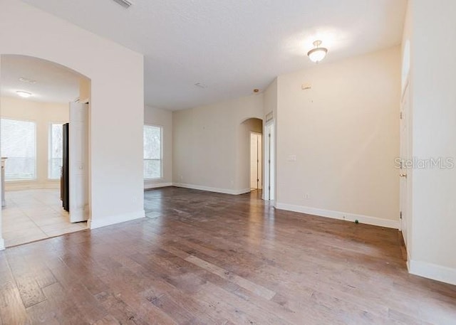 unfurnished room with light wood-type flooring