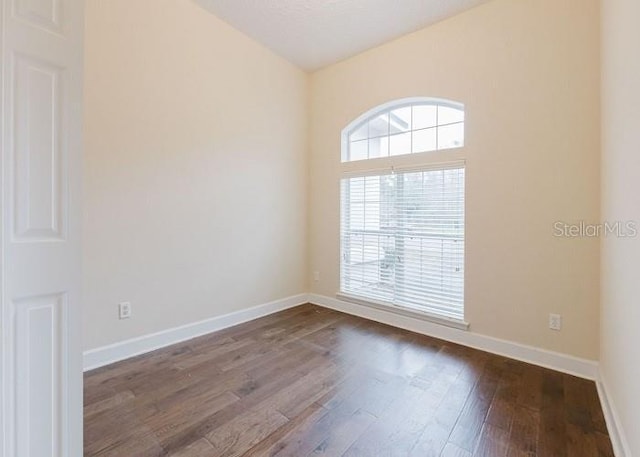 empty room featuring dark hardwood / wood-style flooring