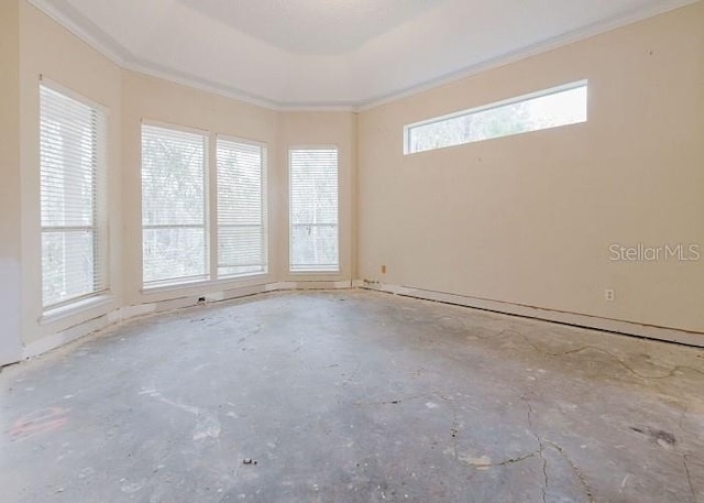 empty room with concrete floors and crown molding