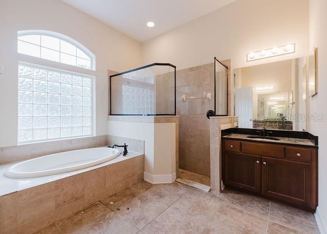 bathroom featuring plus walk in shower and vanity