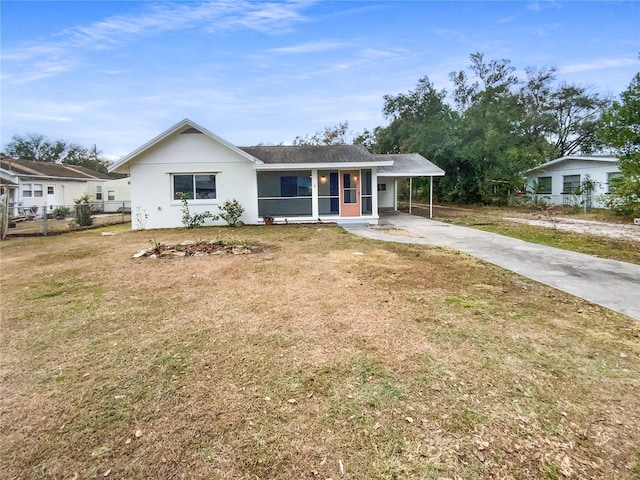 view of front facade with a front yard and a carport