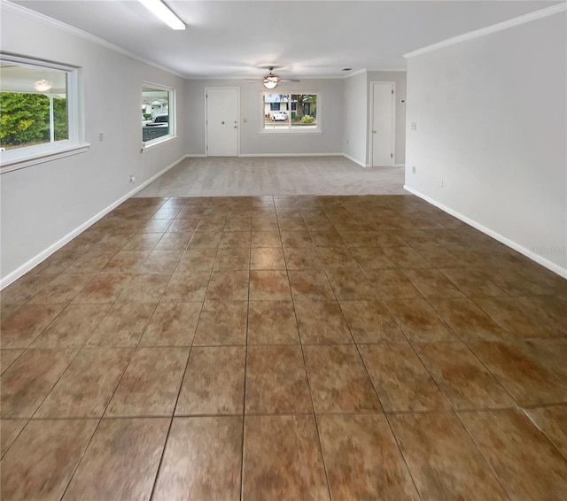 tiled empty room with ceiling fan and ornamental molding